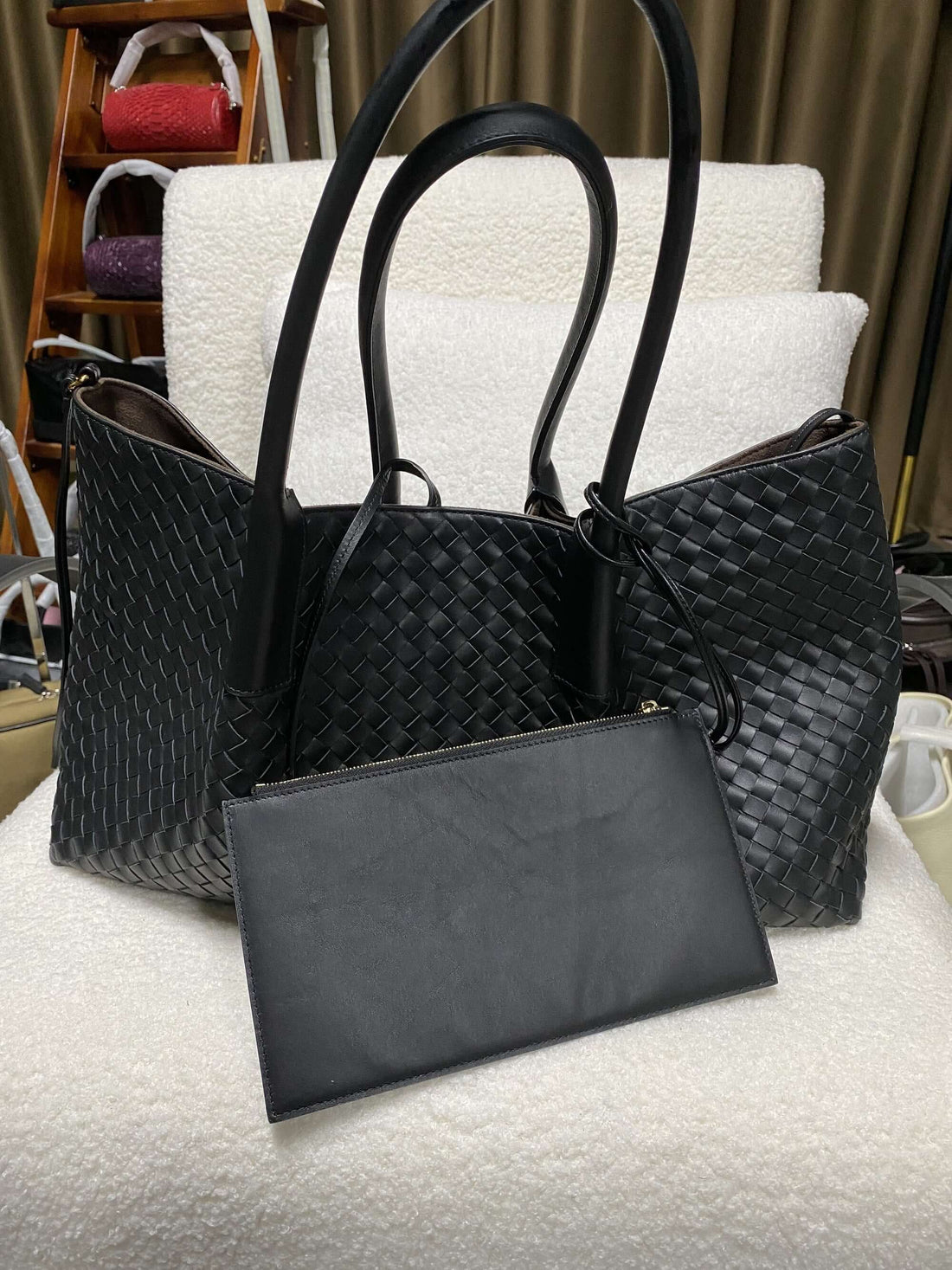Logo-free top-grain cowhide woven tote — black front view with detachable pouch