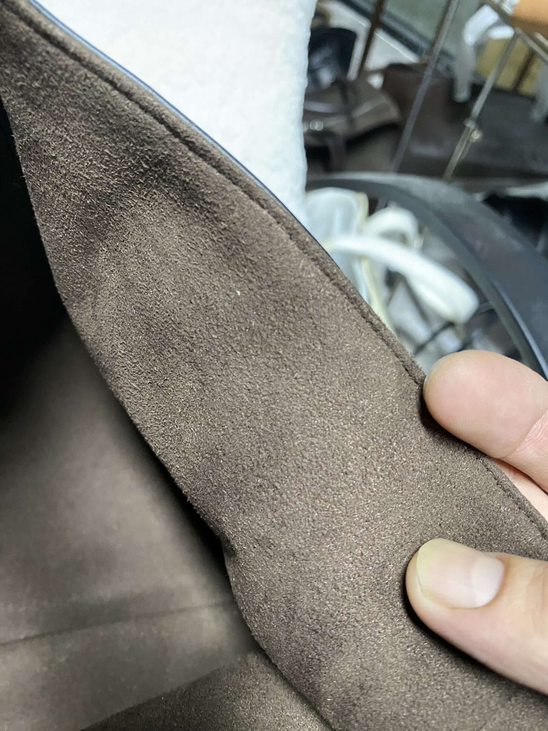 Logo-free top-grain cowhide woven tote — soft brown lining close-up