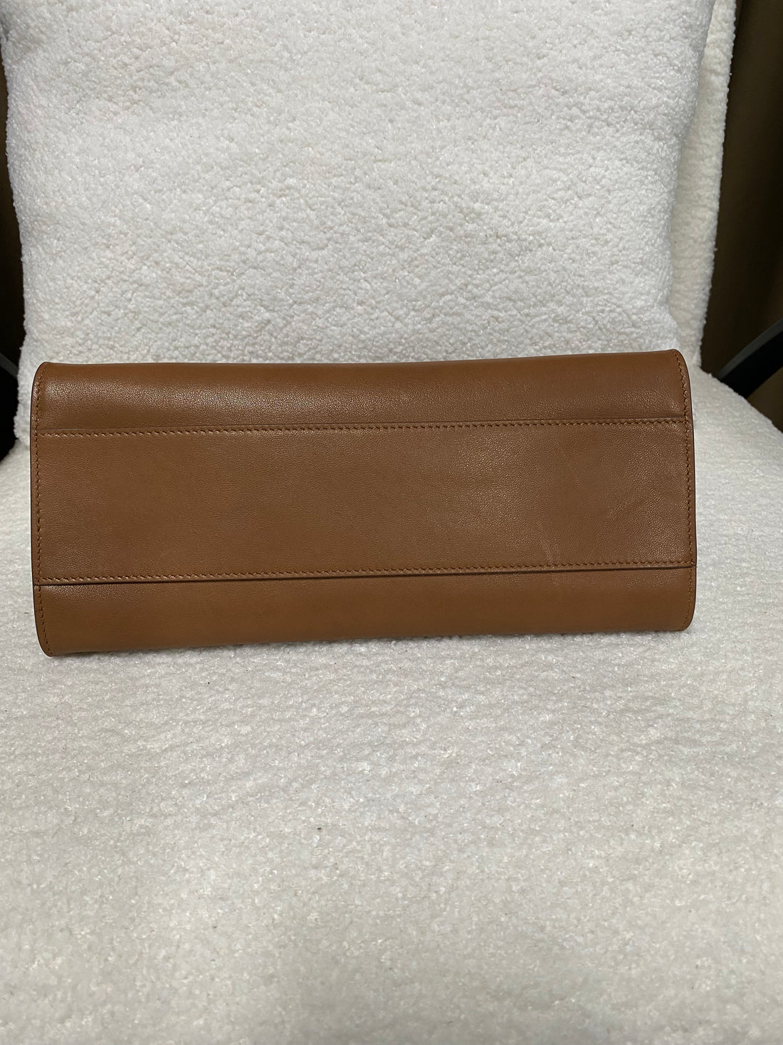Flat leather base of brown shoulder bag