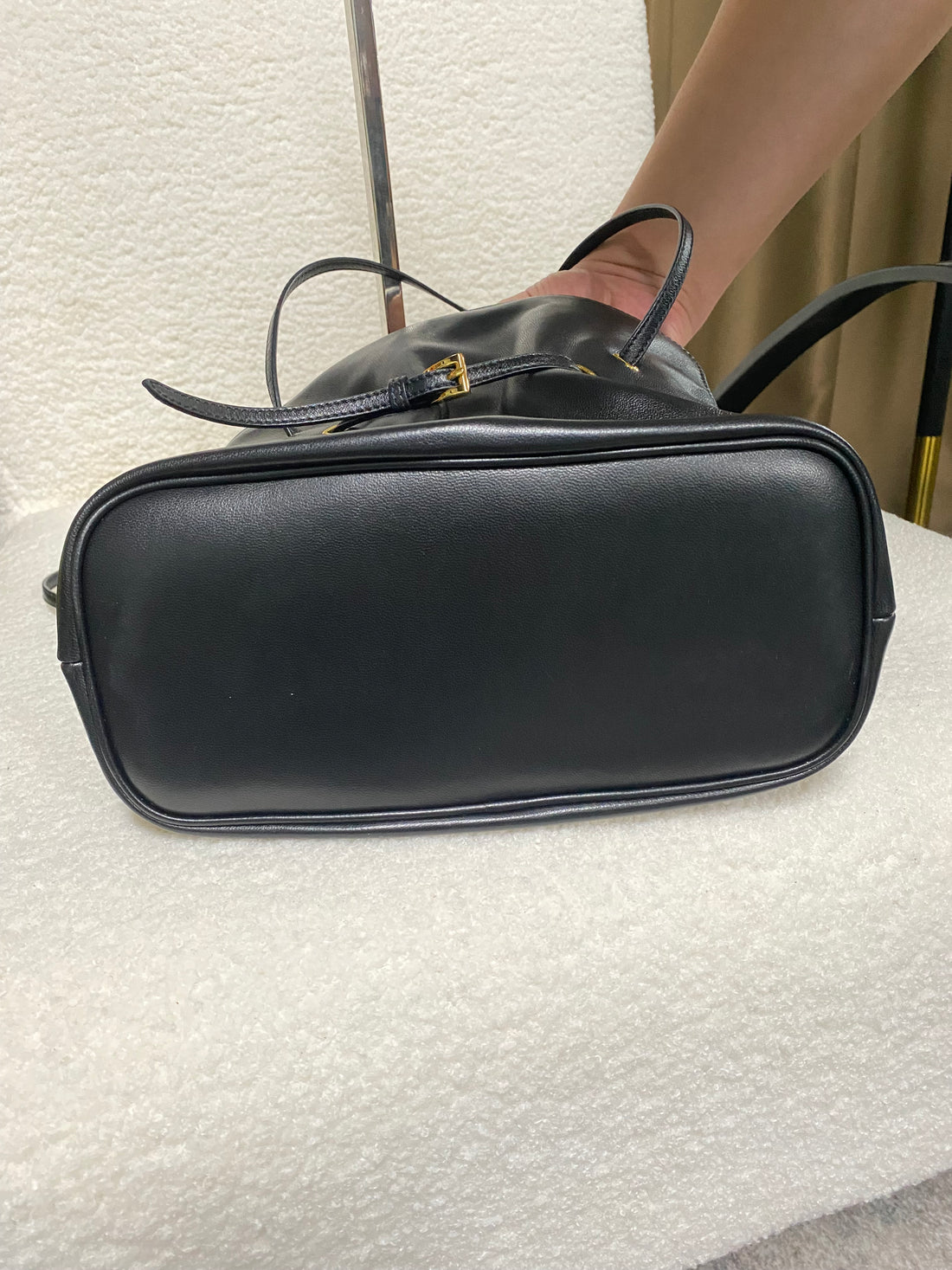 Black ruched lambskin crossbody bag — flat base view