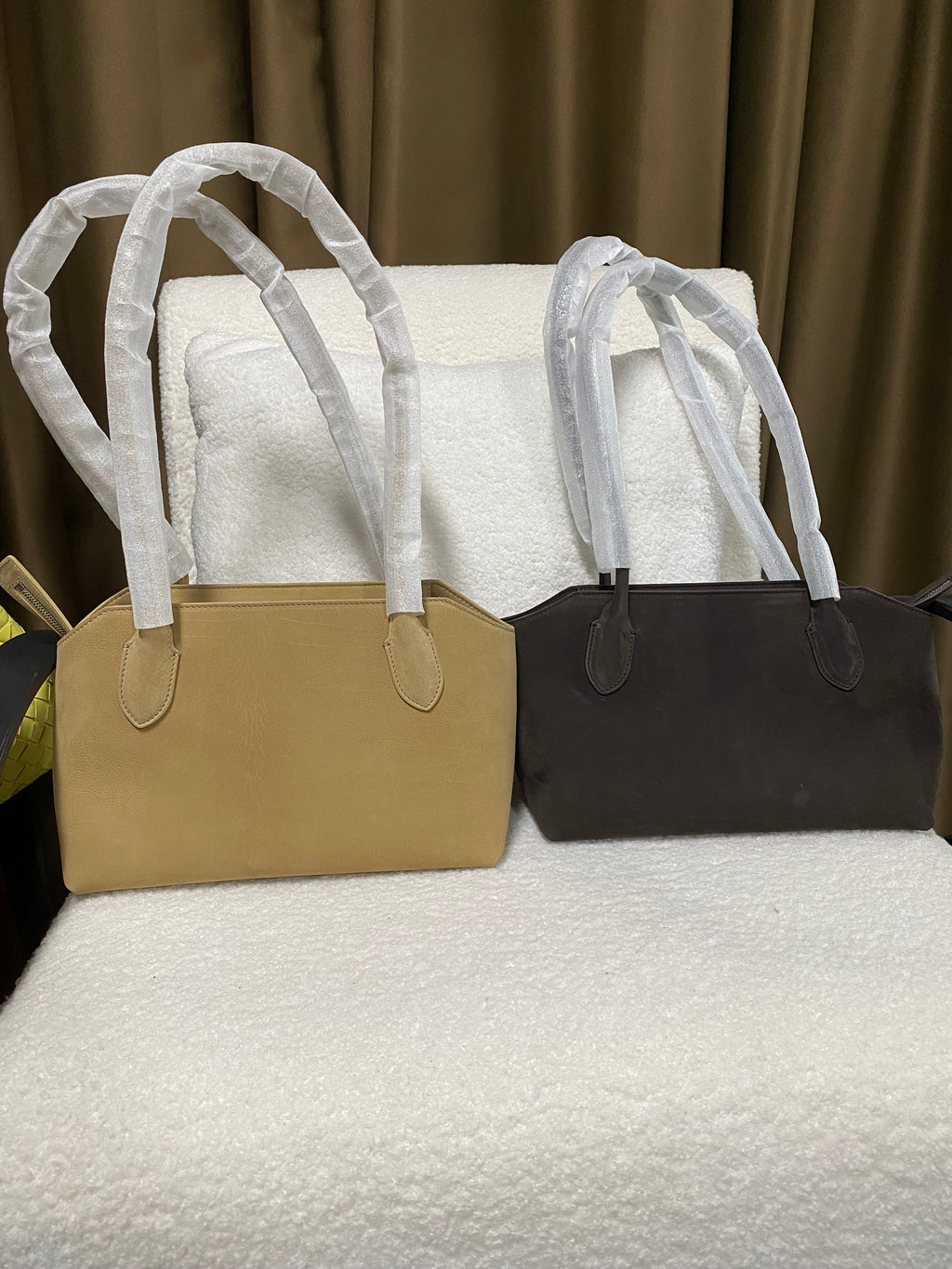 Camel and dark brown baby calfskin tote bags shown side by side