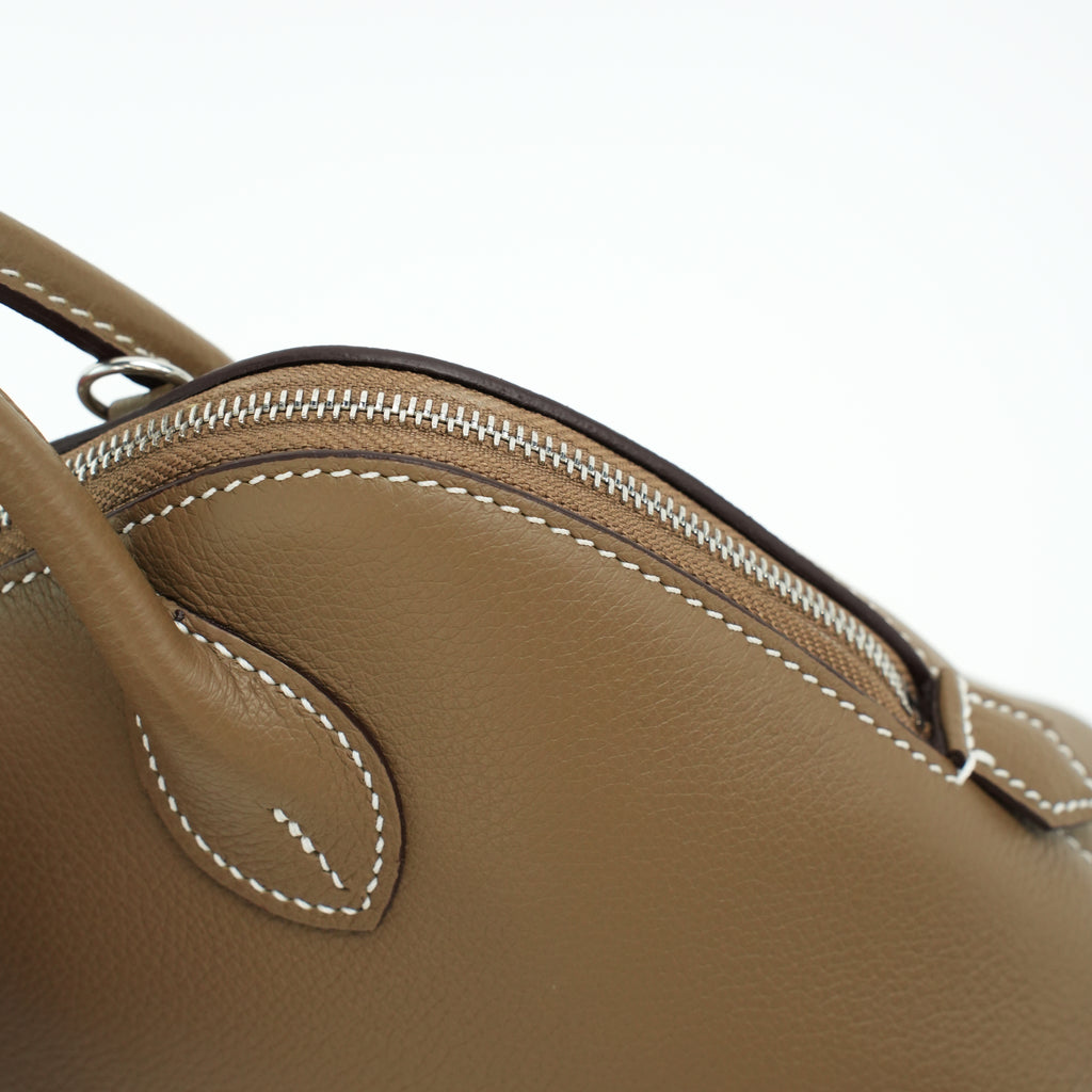 Top zipper detail on taupe top-grain leather dome bag