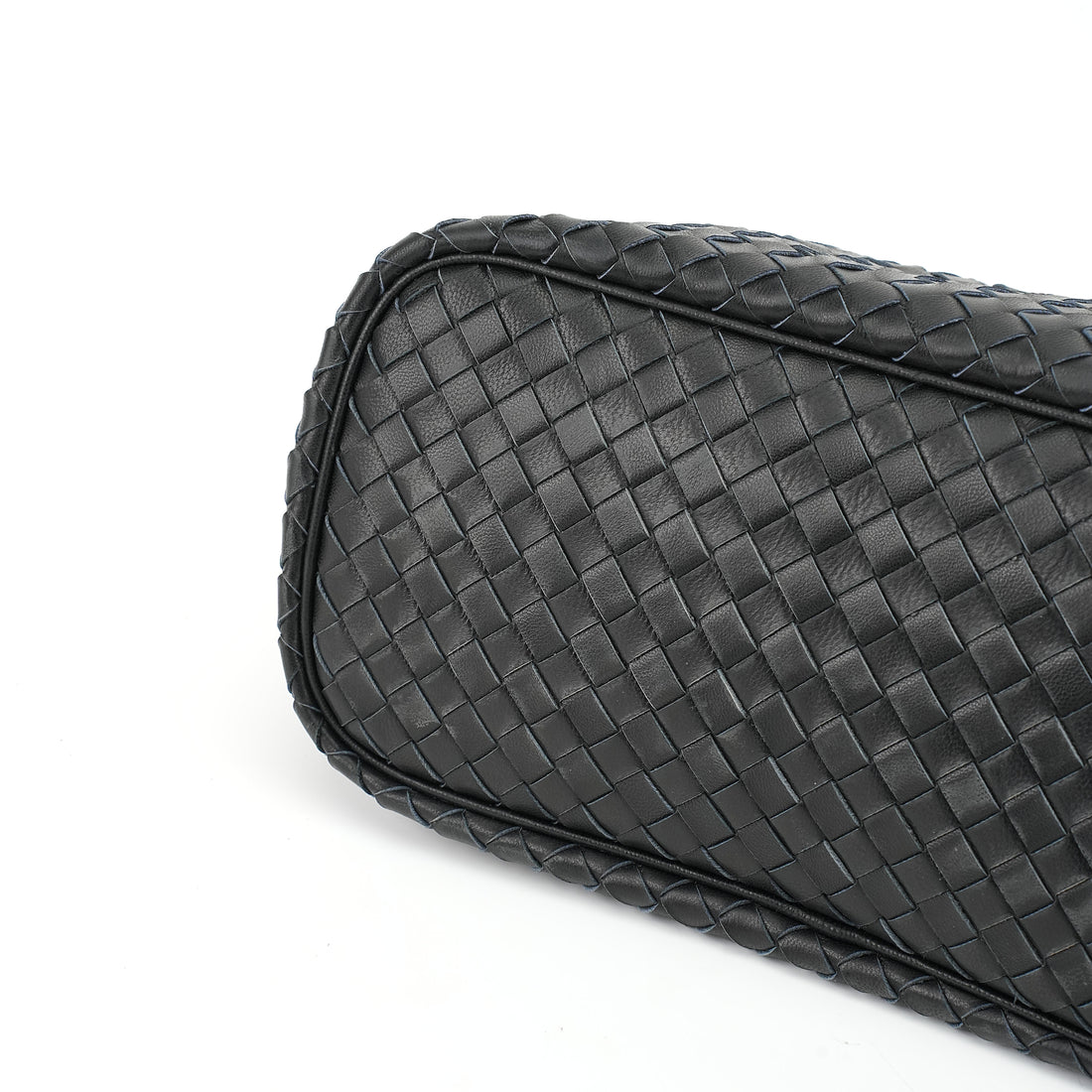 Logo-free handwoven lambskin shoulder bag — black woven leather base close-up