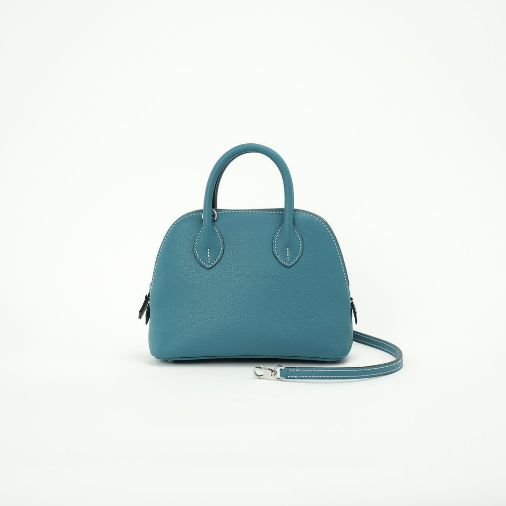 Teal blue top-grain leather dome handbag with crossbody strap