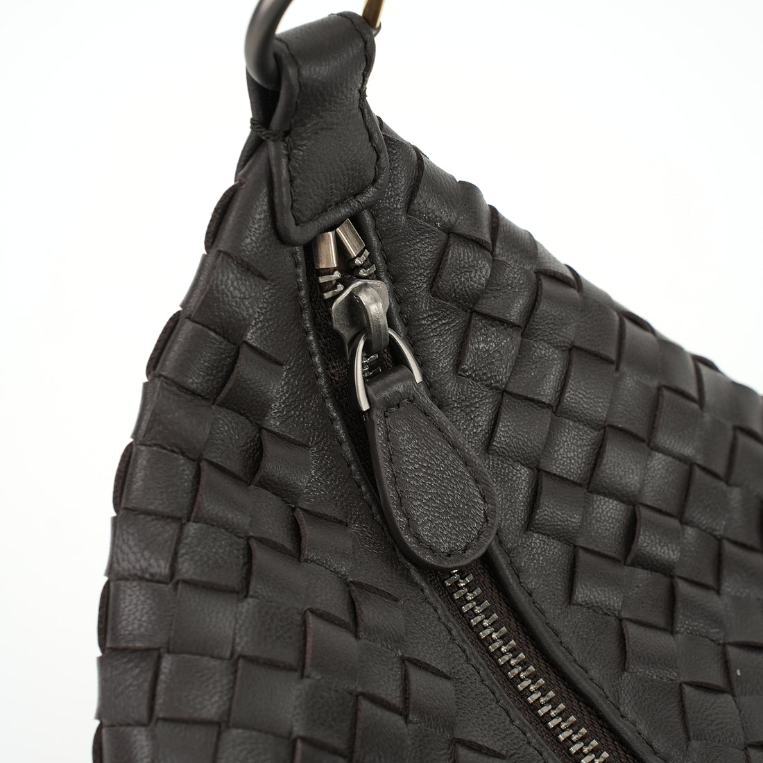 Logo-free handwoven lambskin shoulder bag — black zipper and woven side close-up