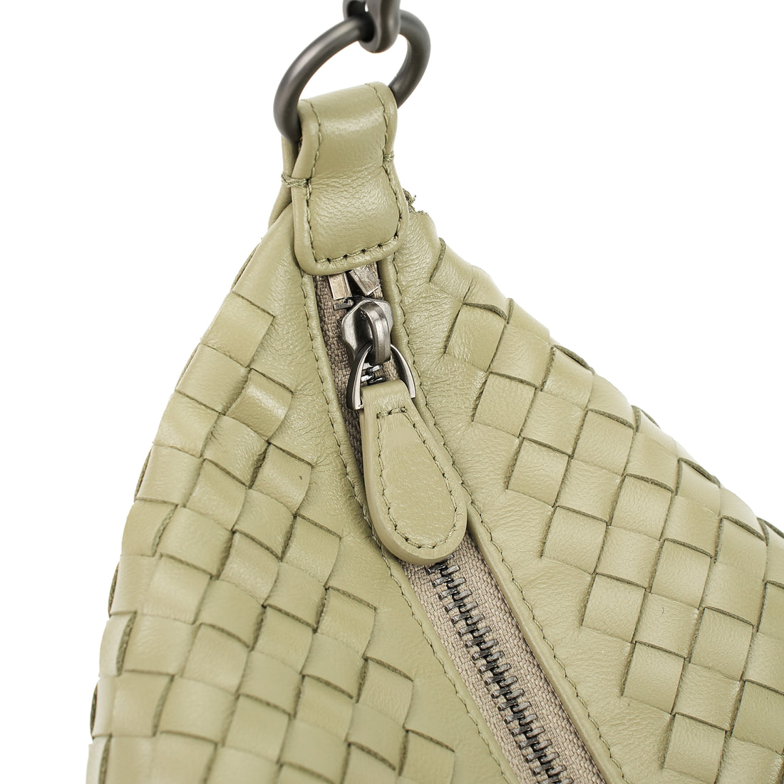 Logo-free handwoven lambskin shoulder bag — butter cream zipper and strap attachment close-up