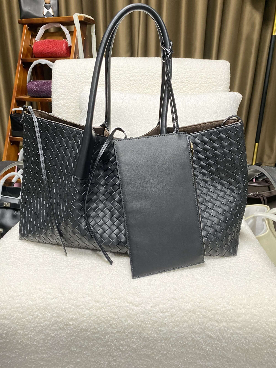 Logo-free top-grain cowhide woven tote — black tote and detachable pouch shown for scale