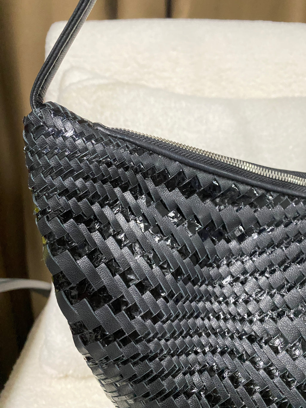 Close-up of handwoven matte and glossy black leather strips