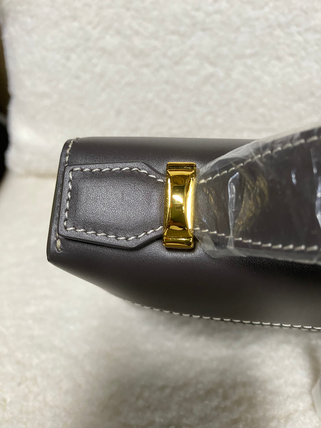 Top-handle attachment and gold hardware on smooth calfskin box bag
