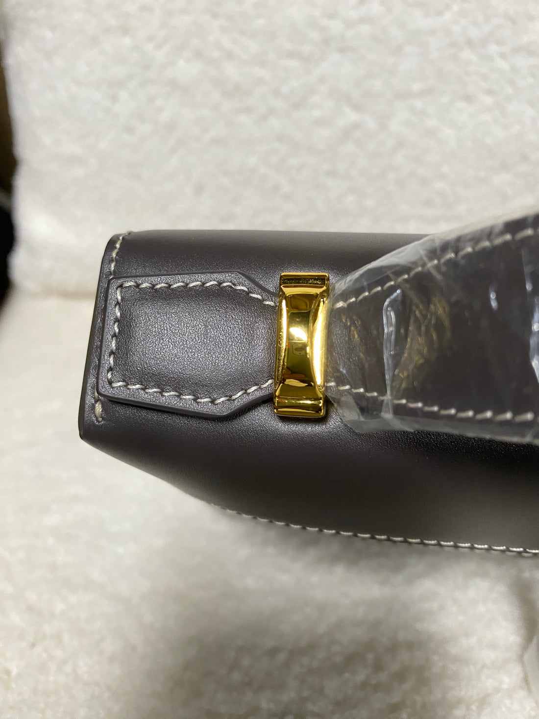 Top-handle attachment and gold hardware on smooth calfskin box bag
