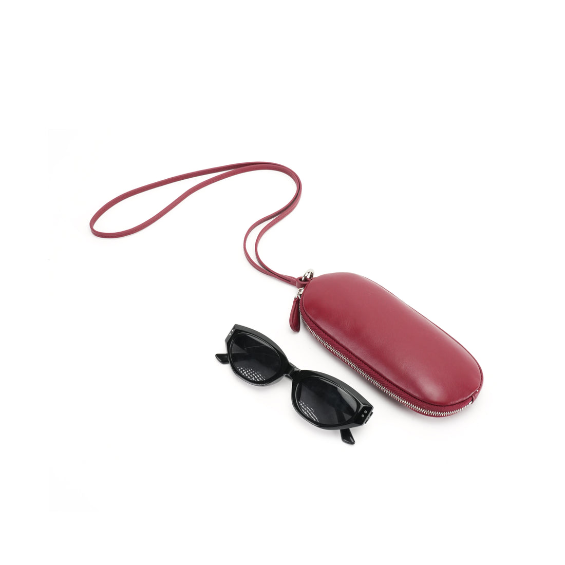 Logo-free cowhide glasses wallet with long strap — burgundy case shown with eyeglasses for scale