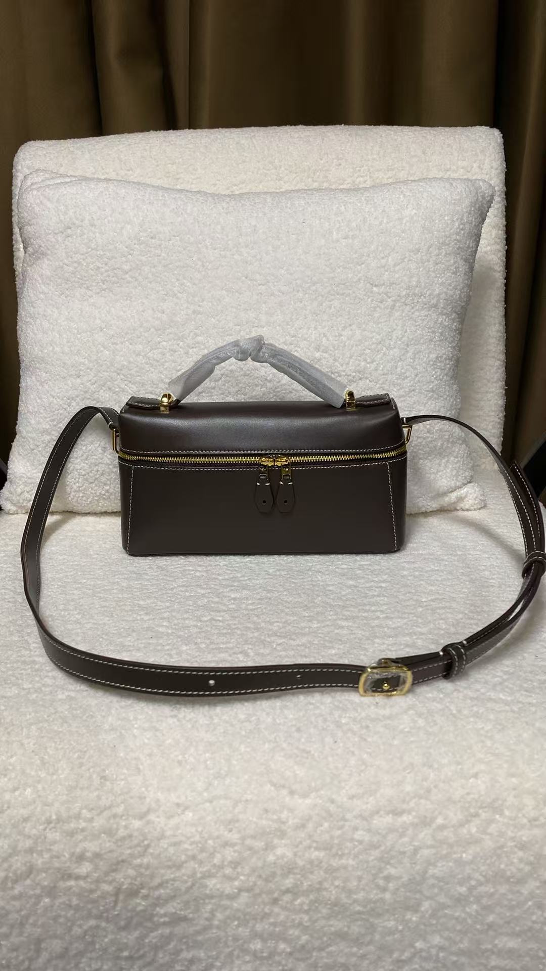 Dark brown calfskin crossbody box bag shown from the front