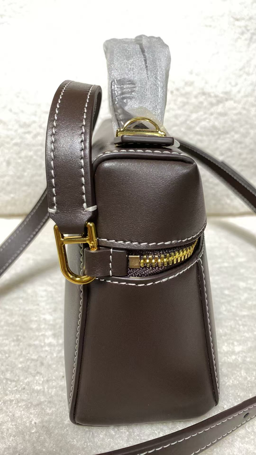 Calfskin box shoulder bag side view with adjustable strap buckle