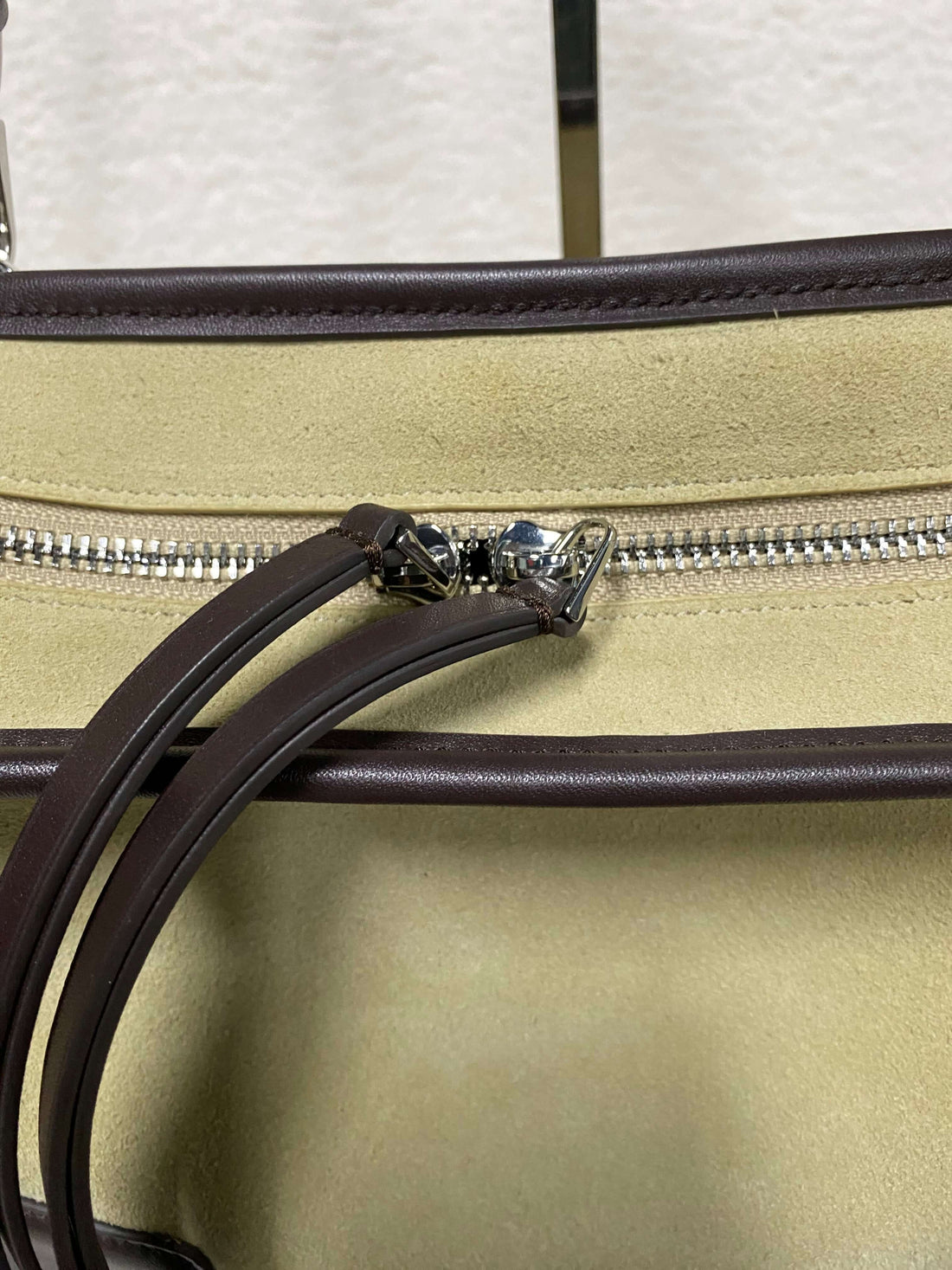 Logo-free two-tone calf suede satchel — double zipper and suede panel close-up