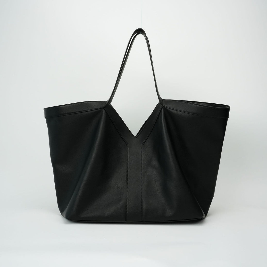 Logo-free black Y-strap slouchy leather tote — three-quarter front view