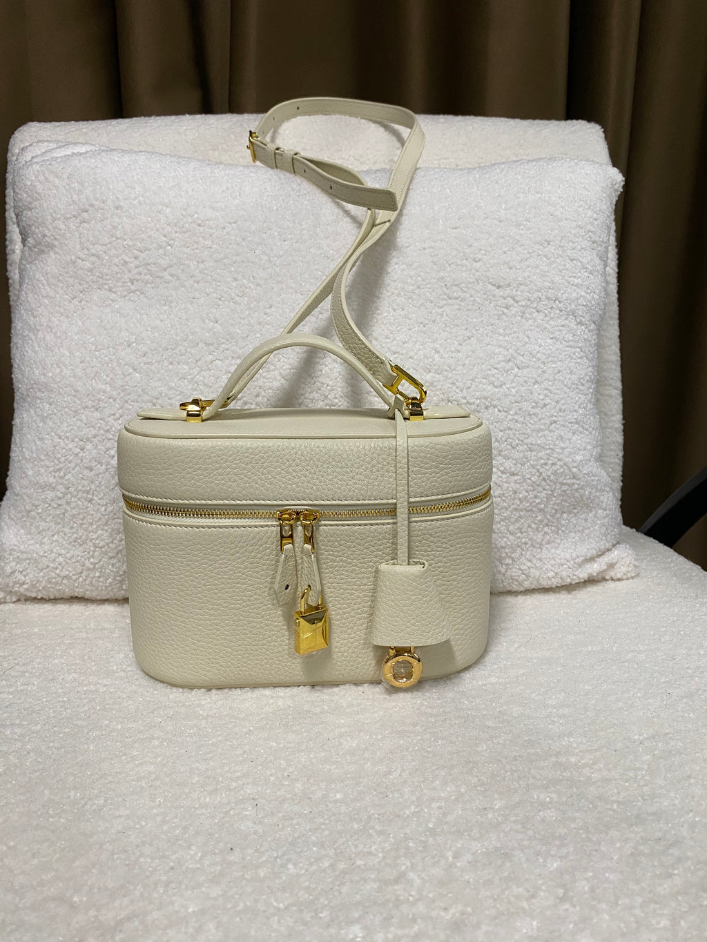 Cream pebbled leather vanity box bag front view with gold hardware
