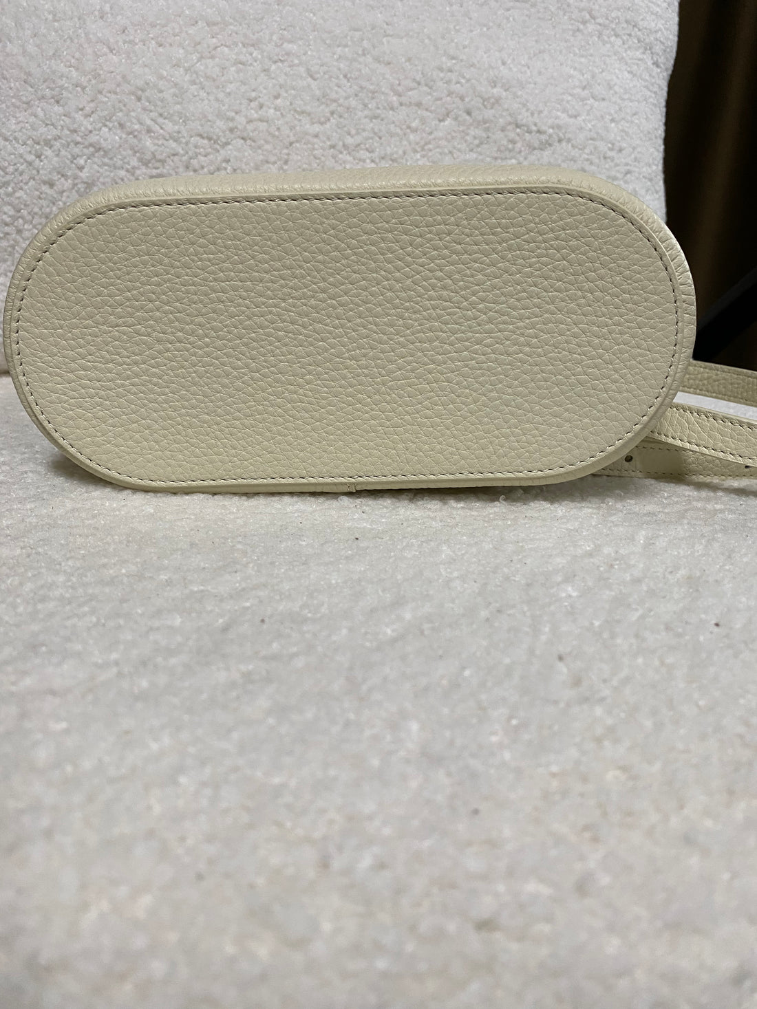 Pebbled leather base of cream vanity box bag