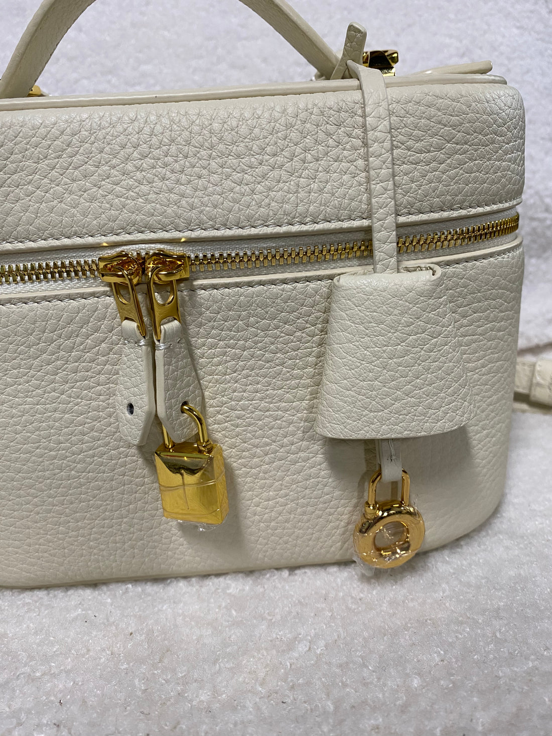 Cream pebbled leather vanity bag side and hardware detail