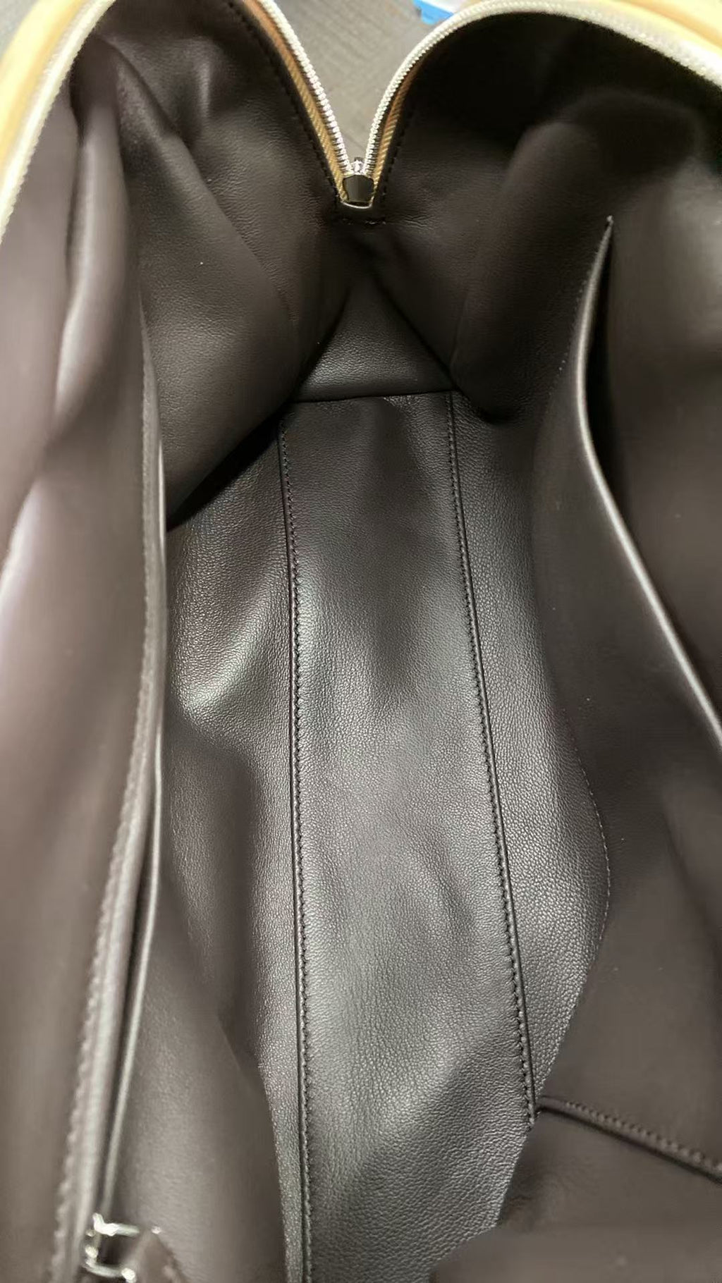 Open dark-lined interior of camel calfskin shoulder bag