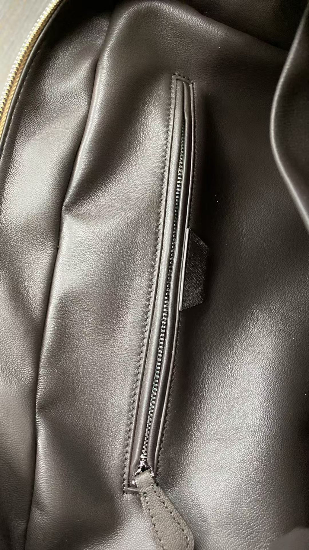 Interior zipper pocket inside camel baby calfskin Boston bag