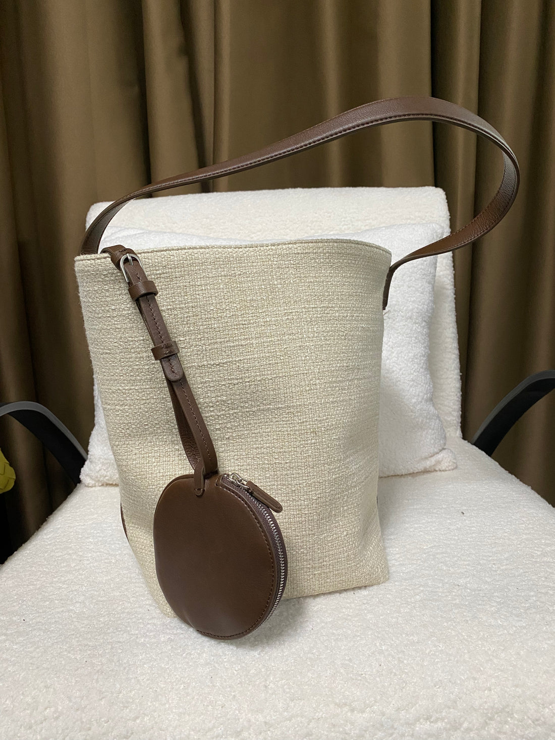 Front view of linen and leather bucket tote with coin pouch
