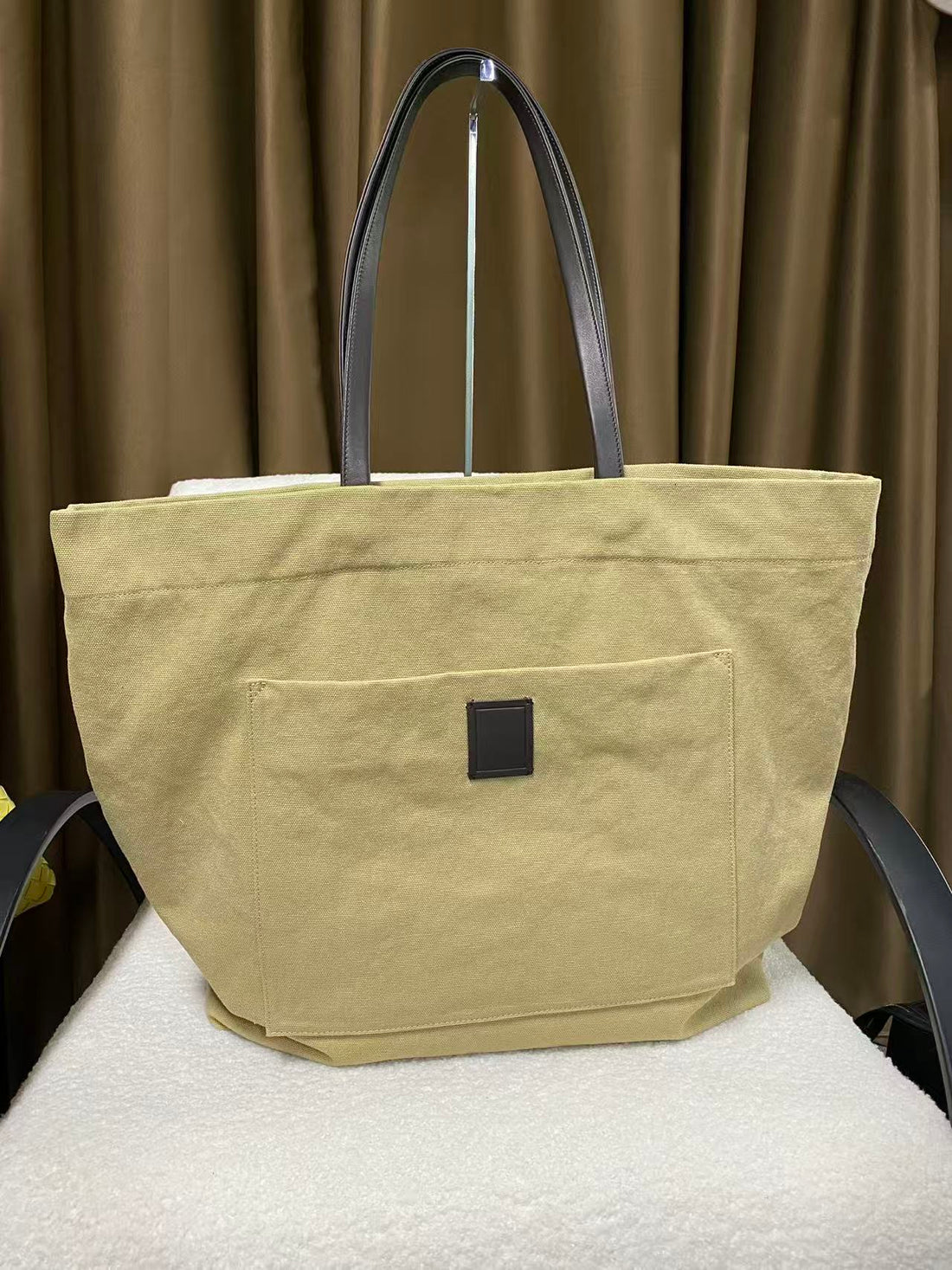 Warm sand slouchy canvas tote front view with leather handles