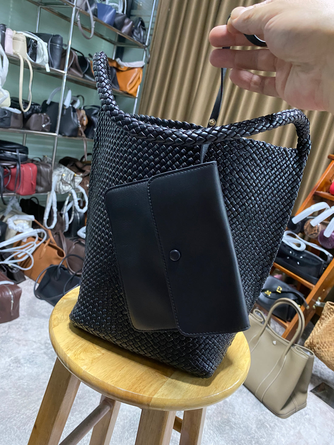 Logo-free black handwoven lambskin bucket bag — front view with detachable pouch