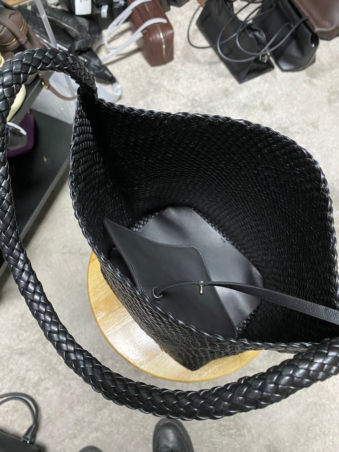 Logo-free black handwoven lambskin bucket bag — open interior with detachable pouch