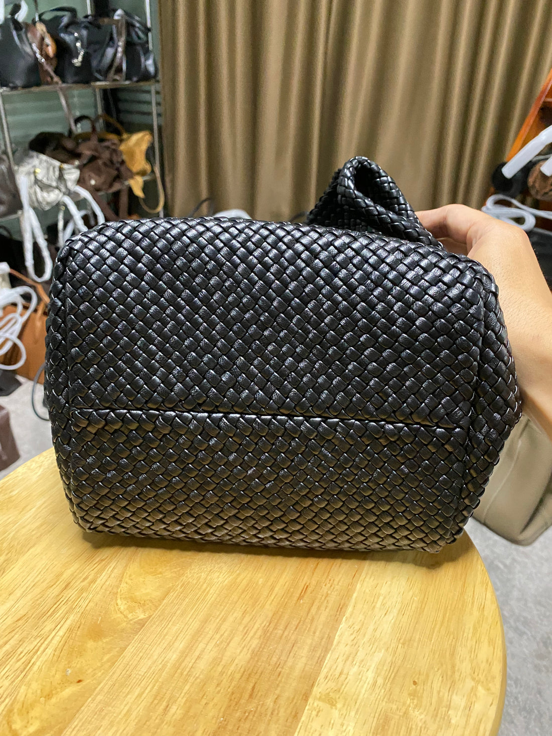 Logo-free black handwoven lambskin bucket bag — handwoven leather base view
