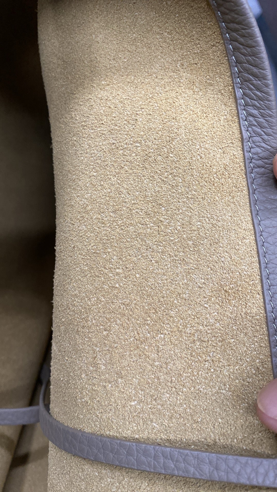 Soft suede interior lining close-up inside taupe leather tote