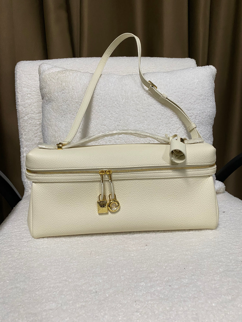 Cream white structured leather handbag front view with gold double zipper
