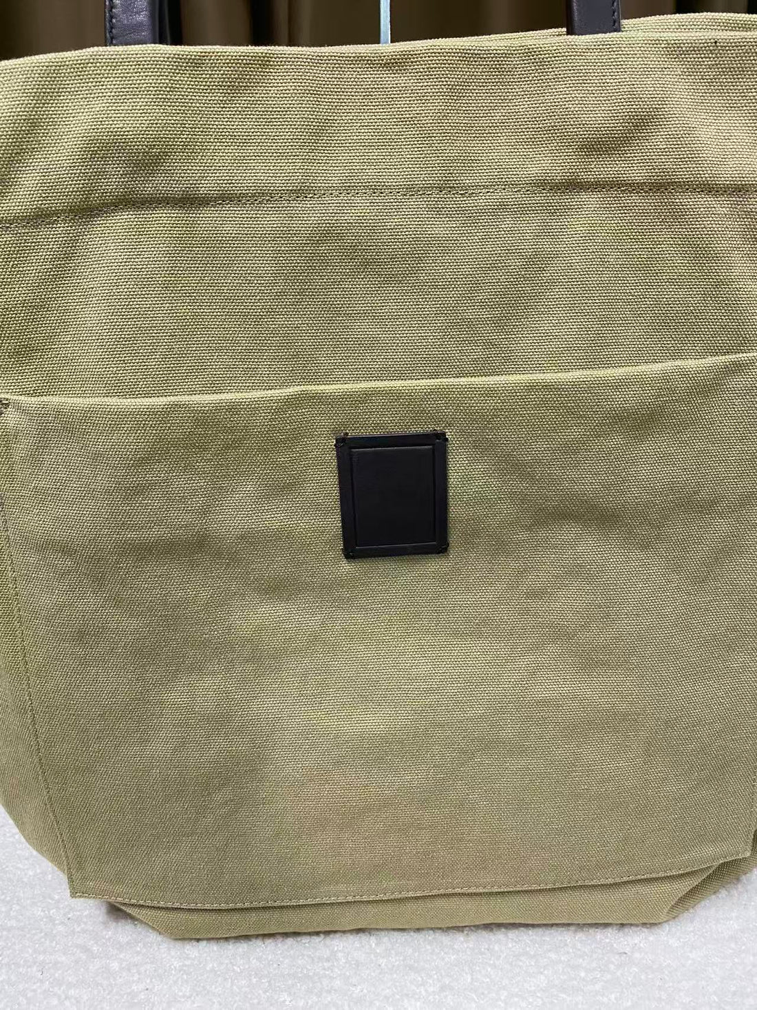 Front slip pocket on washed sand canvas tote