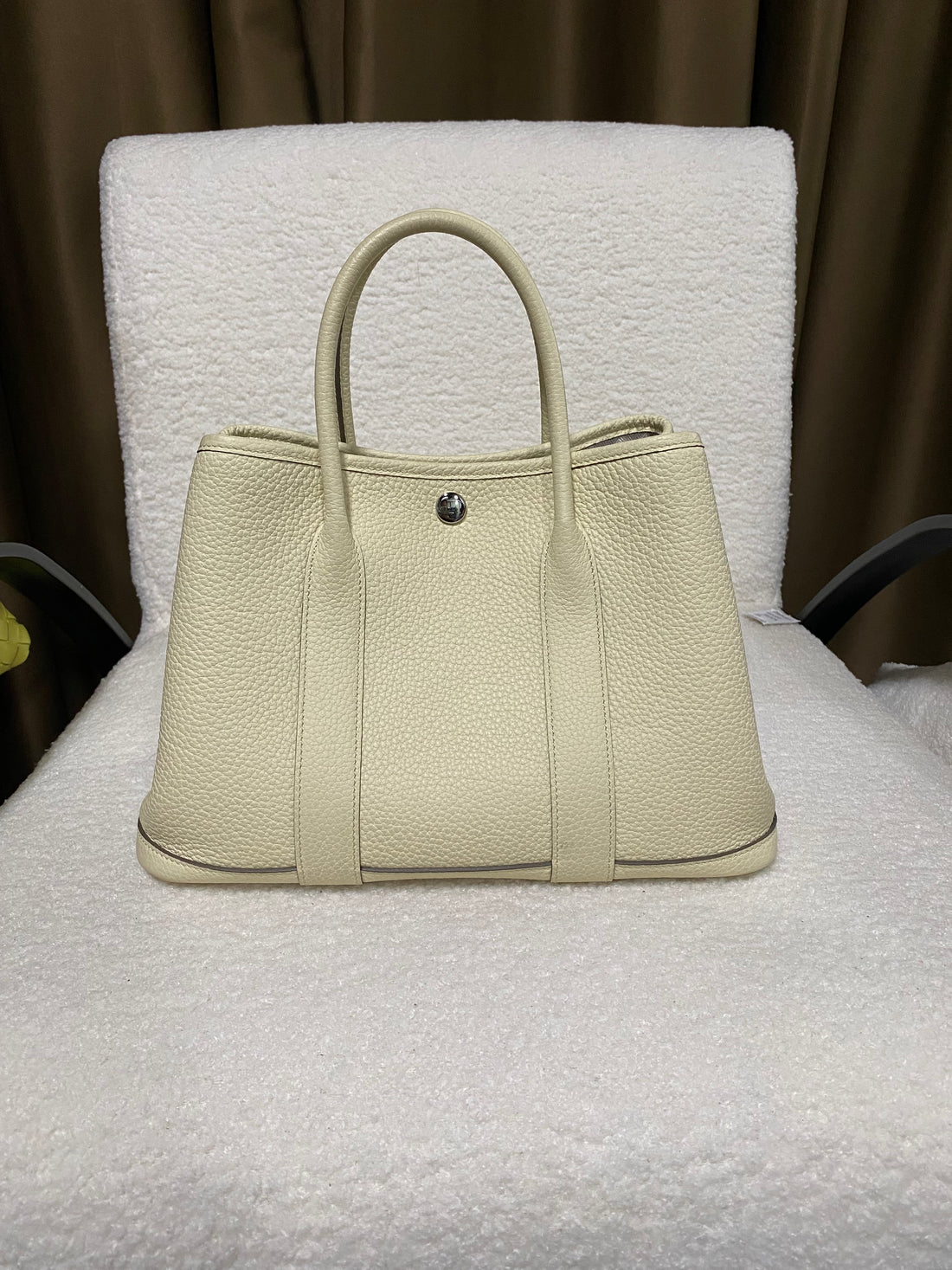 Cream wide-top leather snap tote front view