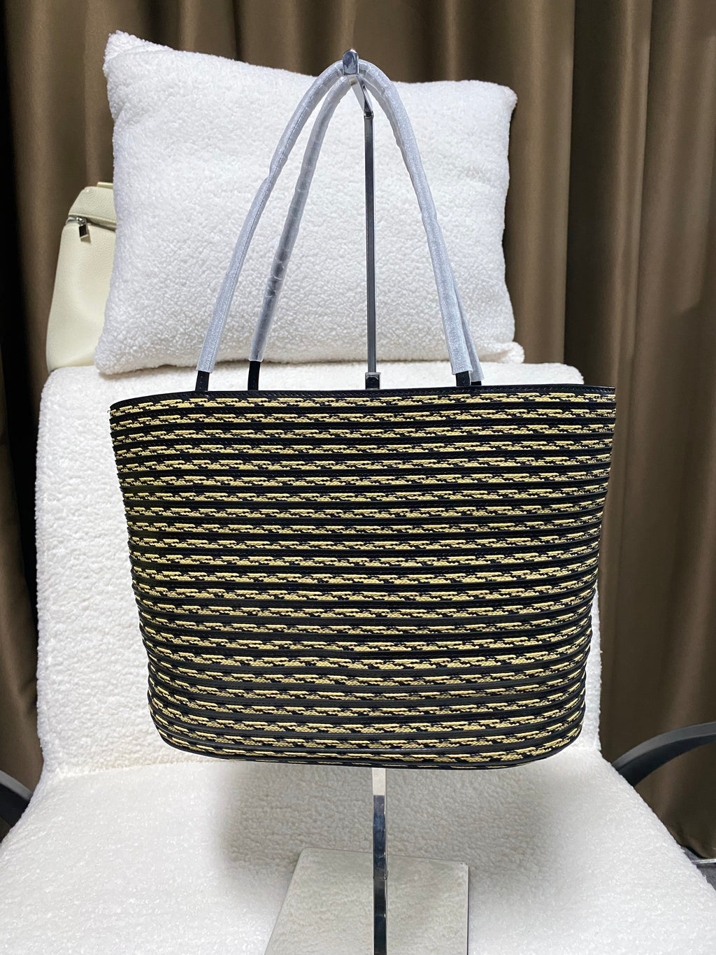 Logo-free handwoven striped bucket tote — black and tan front view