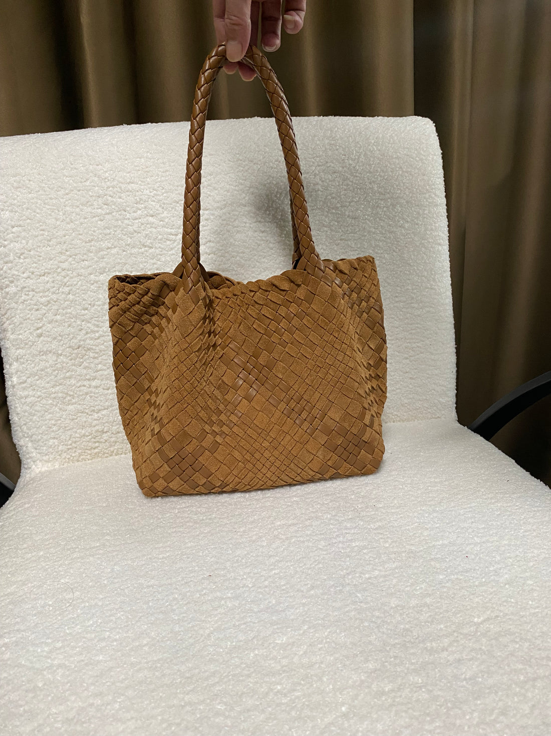Handwoven full-grain leather tote — cognac front view on a white chair