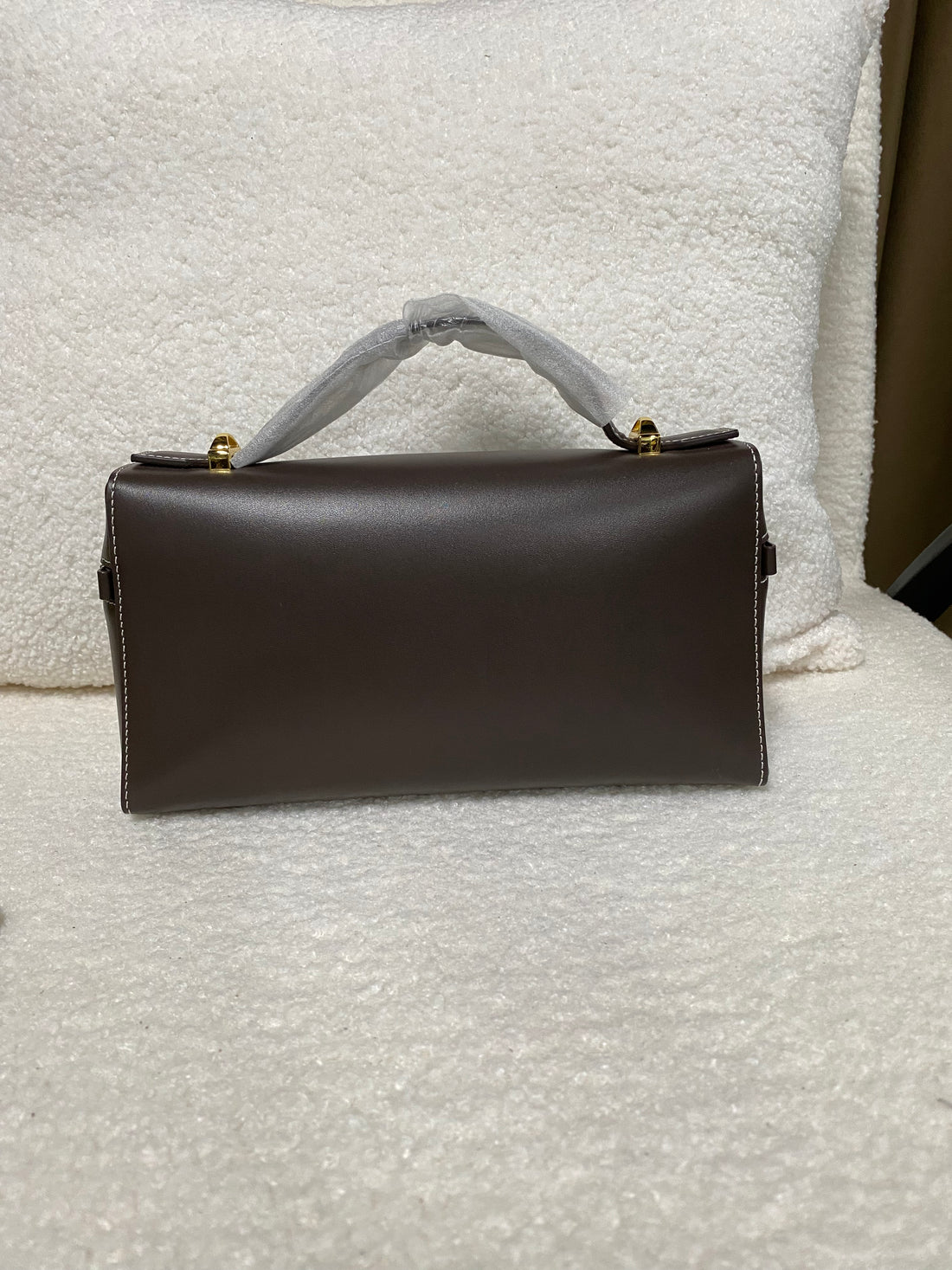 Dark brown calfskin box bag back view showing clean rectangular shape