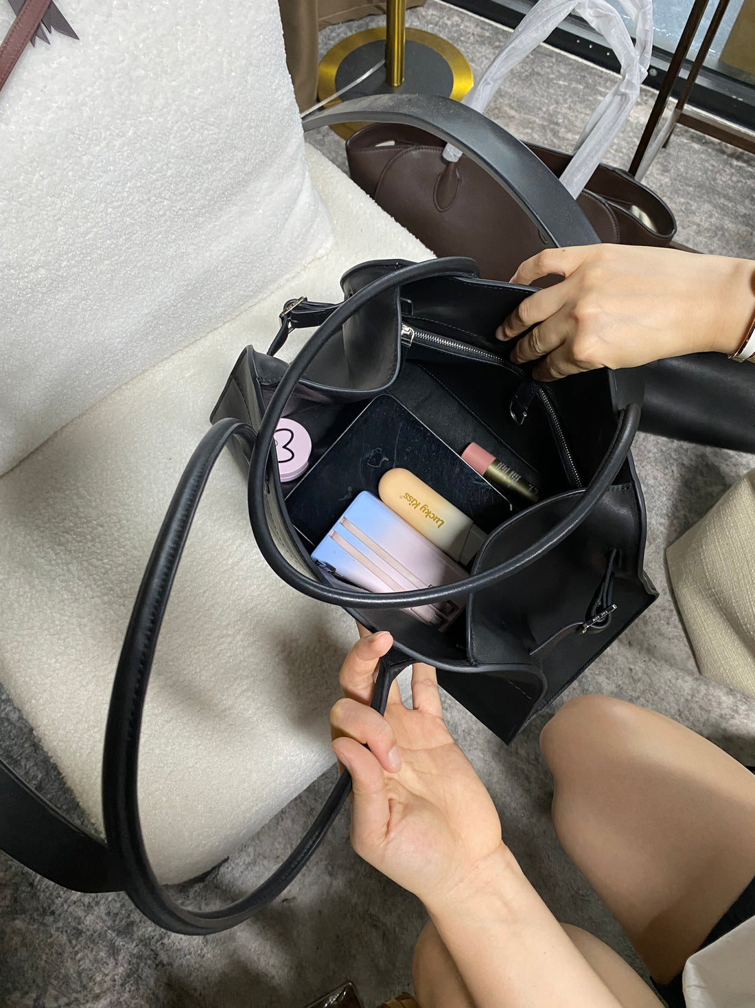 Logo-free black cowhide work tote — open interior with detachable pouch