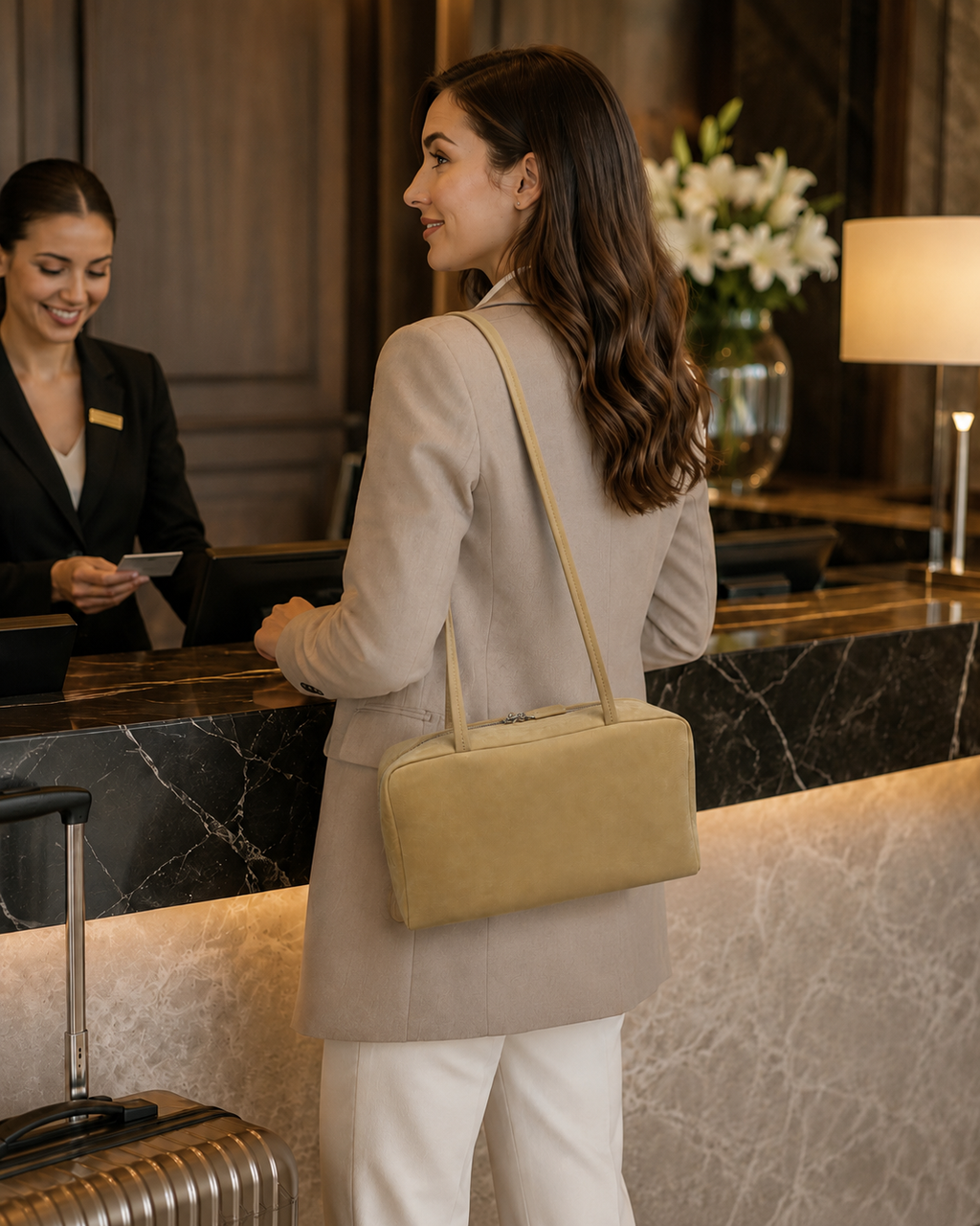 Woman carrying a camel baby calfskin Boston shoulder bag