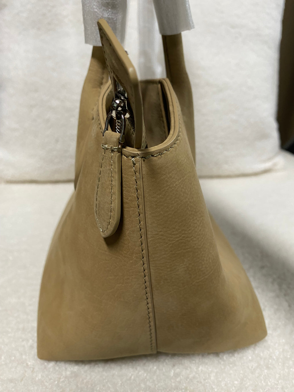 Camel baby calfskin tote bag side profile with top zipper