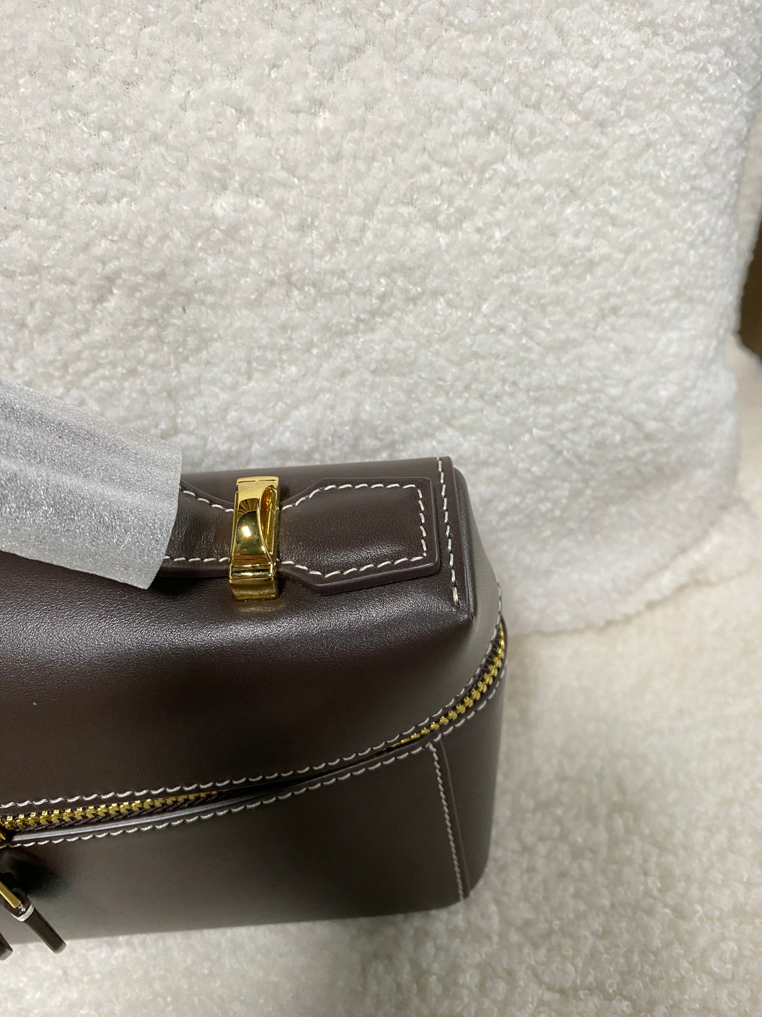 Gold perimeter zipper corner on dark brown calfskin box handbag