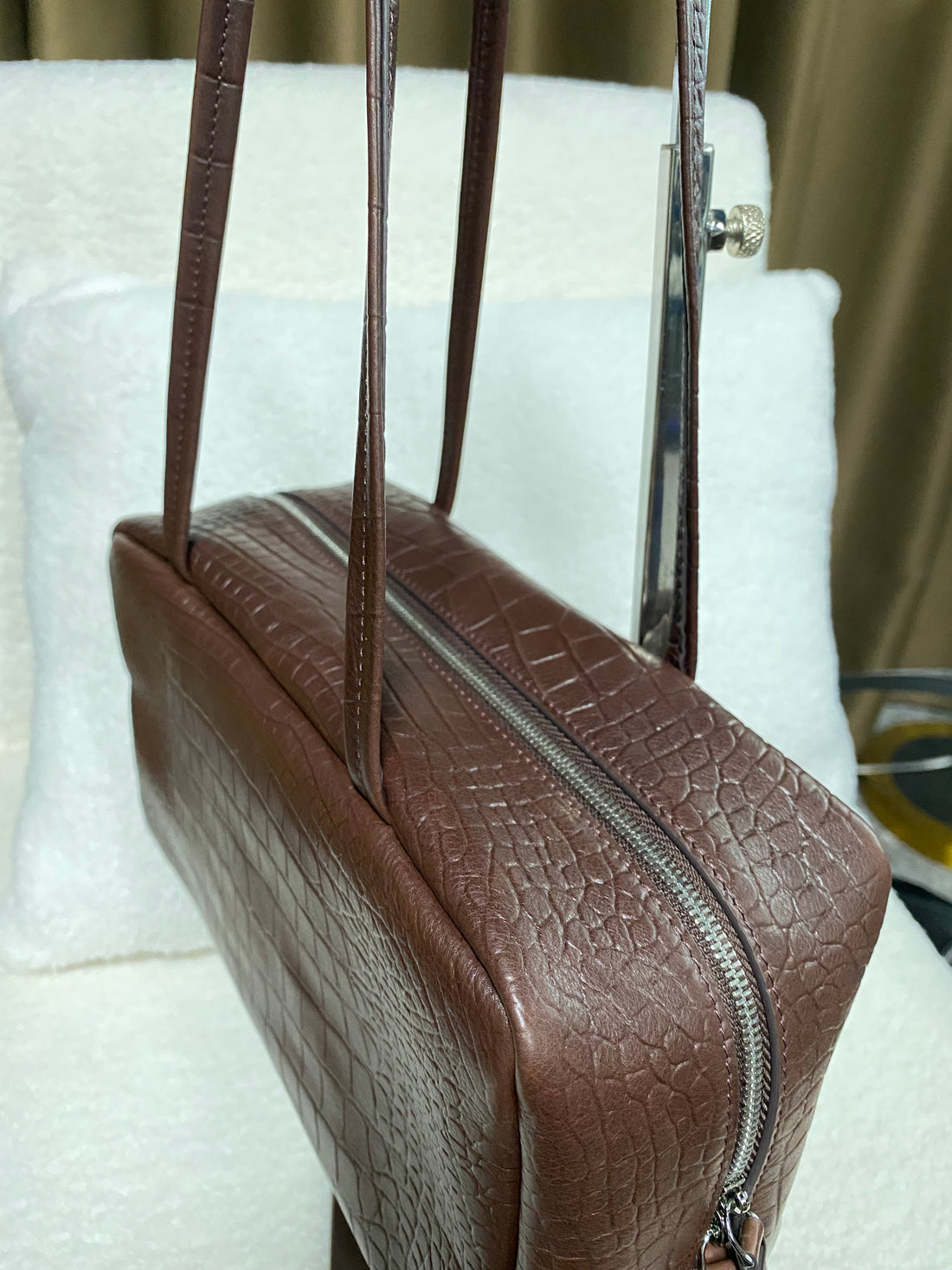 Logo-free cognac croc-embossed cowhide shoulder bag — three-quarter top view