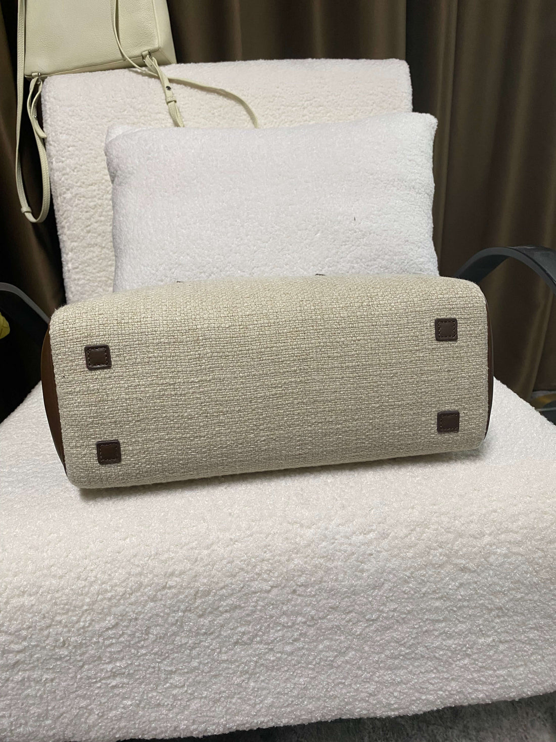 Logo-free linen and calf leather top-handle bag — woven linen base with protective feet