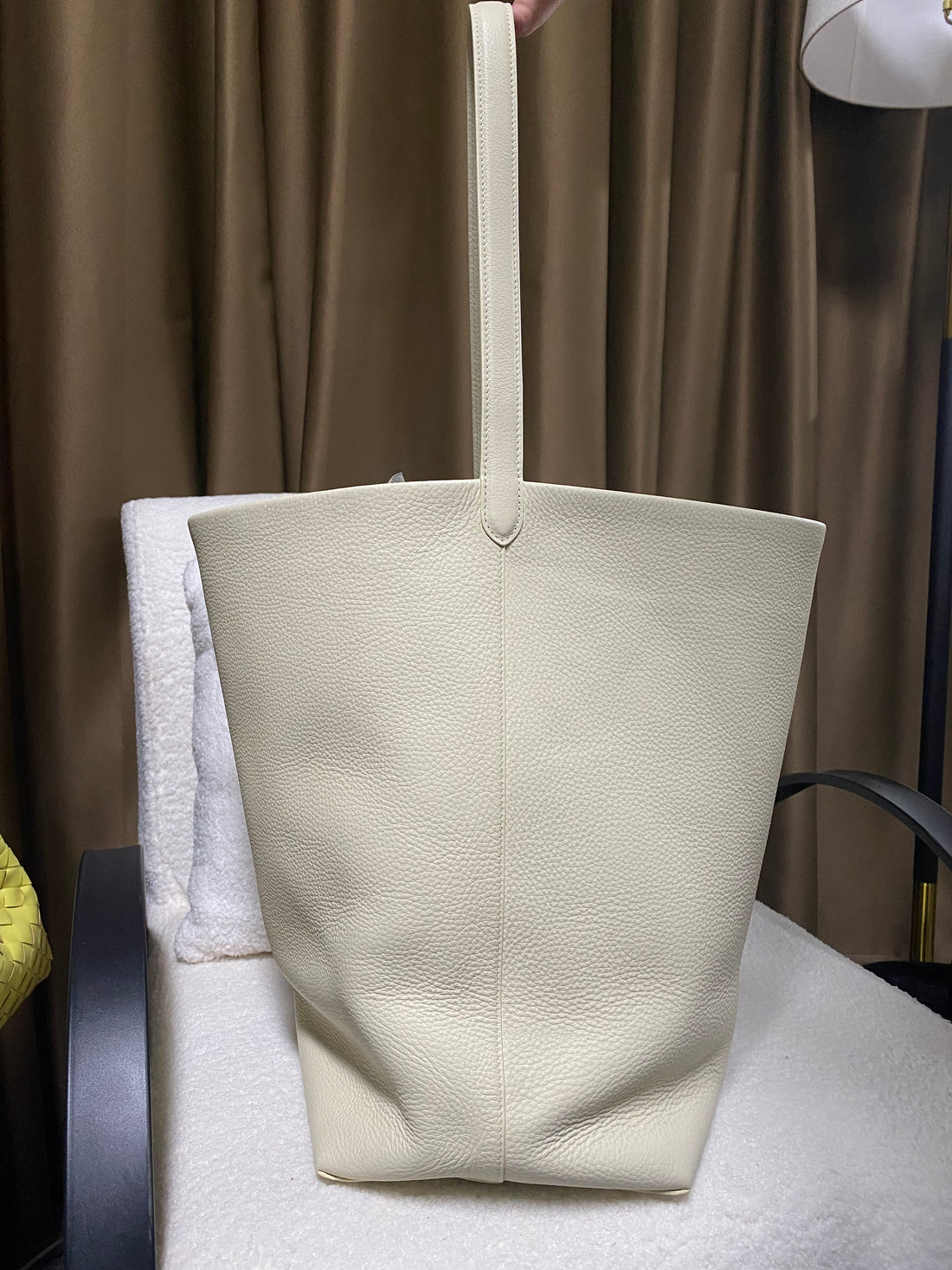 Cream slouchy leather bucket tote front view with wide opening