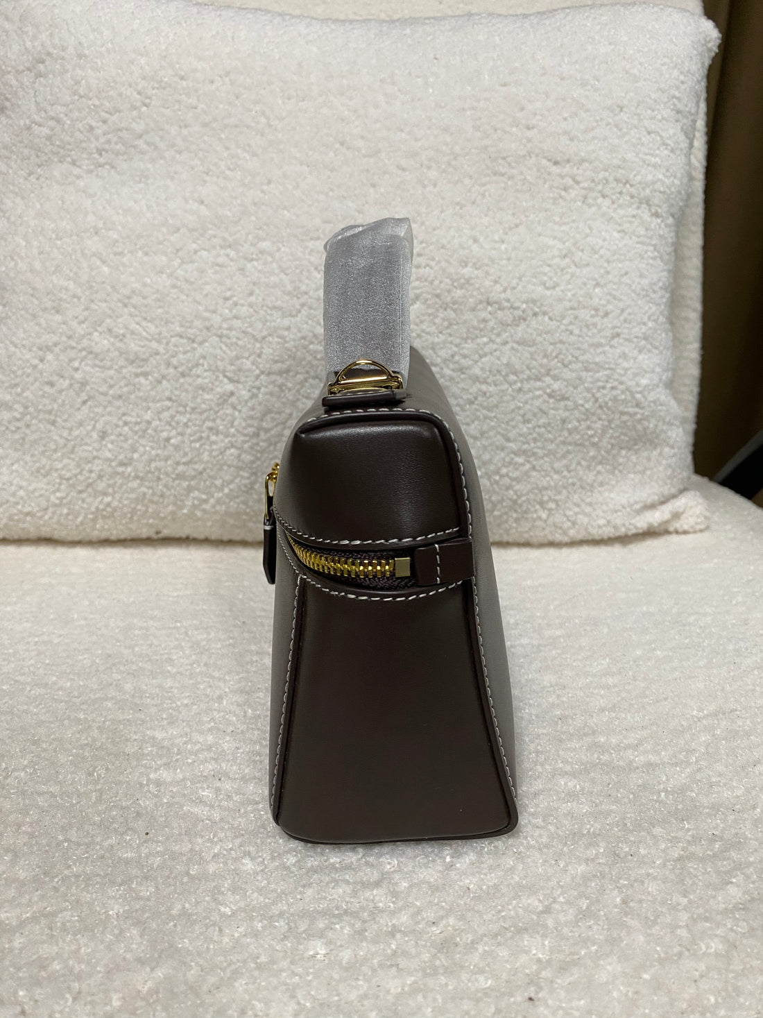 Structured side profile of dark brown calfskin box shoulder bag