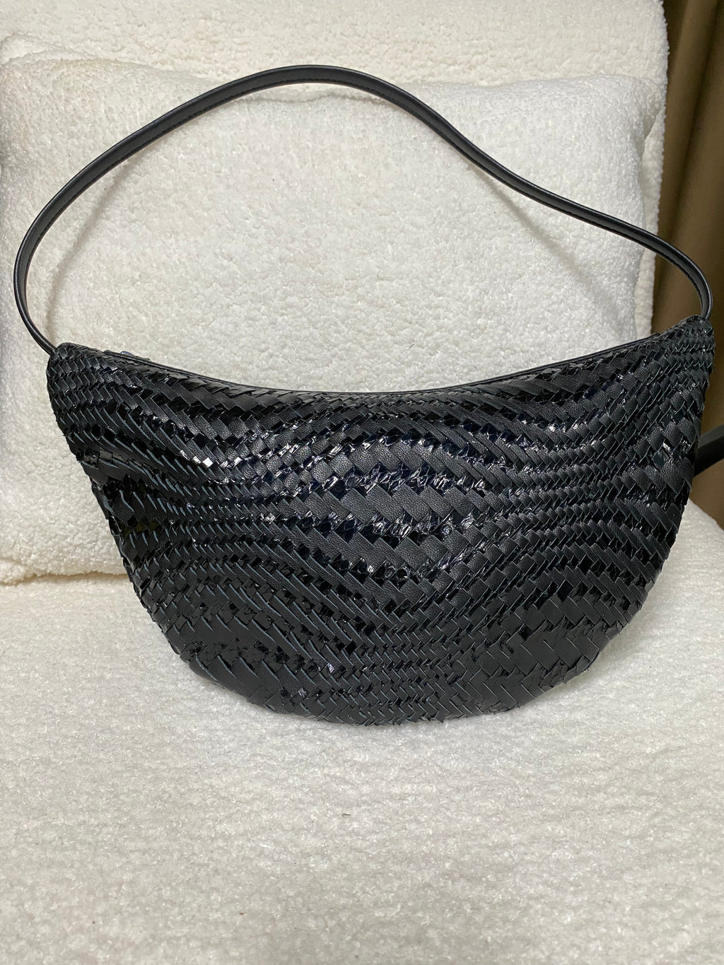 Black woven leather crescent hobo bag front view