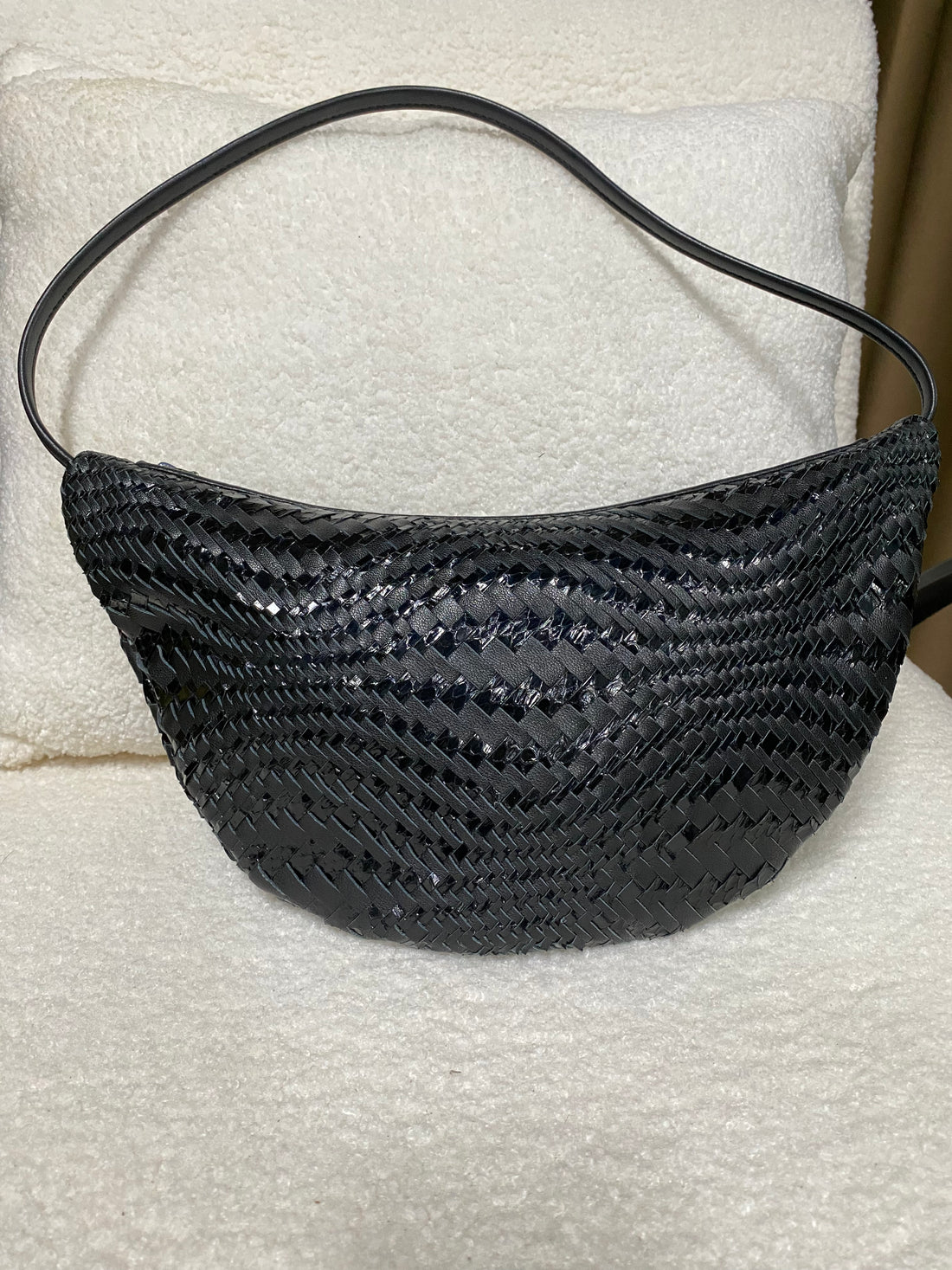 Black woven leather crescent hobo bag front view