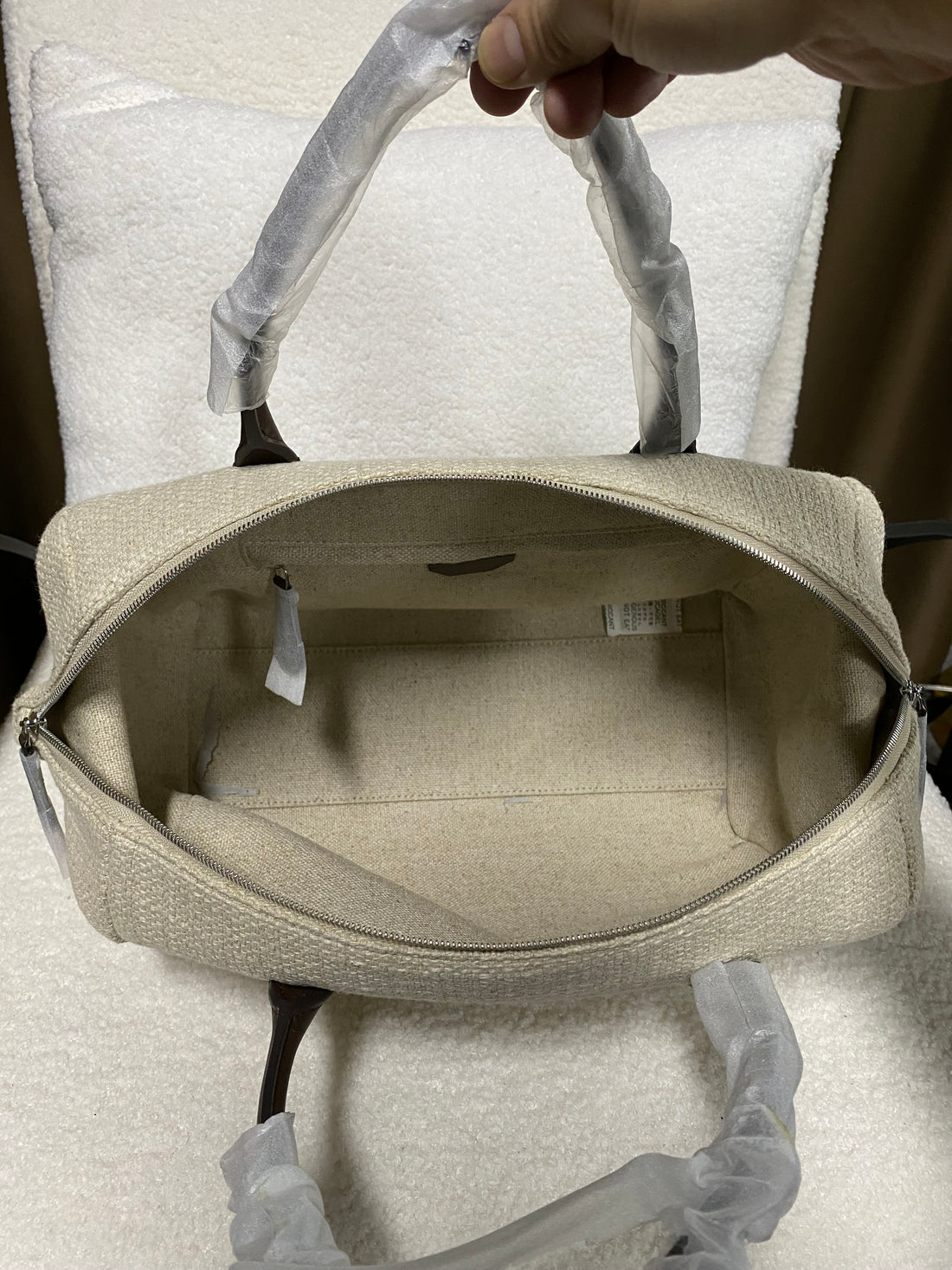 Open spacious interior of linen Boston handbag