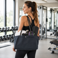 Woman carrying a navy canvas tote bag with long leather shoulder straps