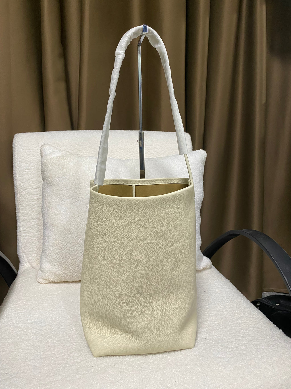 Cream full-grain leather bucket tote side profile