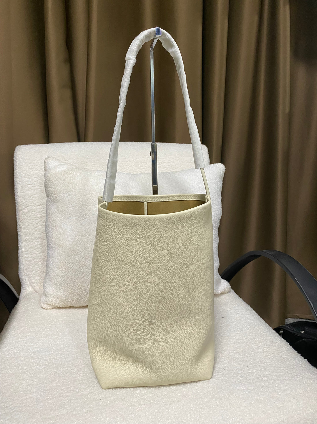 Cream full-grain leather bucket tote side profile